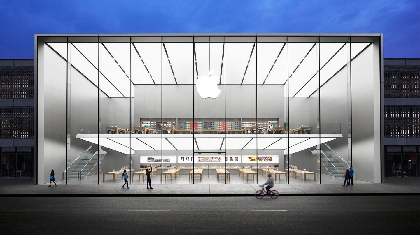 Exterior view of Apple West Lake store front featuring a 15 meter tall glass facade divided horizontally by a dramatic cantilevered floor with a glass staircase on either side of the store
